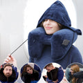 Woman relaxing in airplane seat wearing navy blue hooded inflatable travel neck pillow